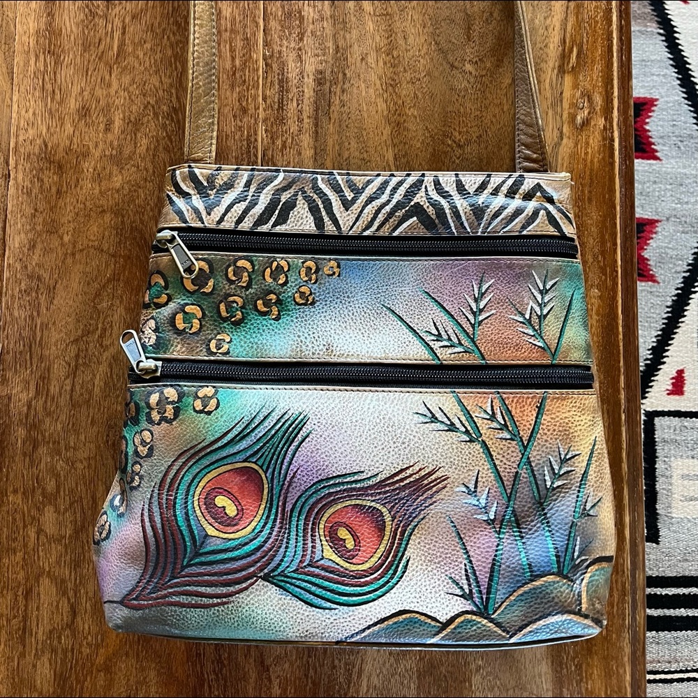 Hand painted and signed Anuschka leather purse. 10” wide by 9” tall cross body.